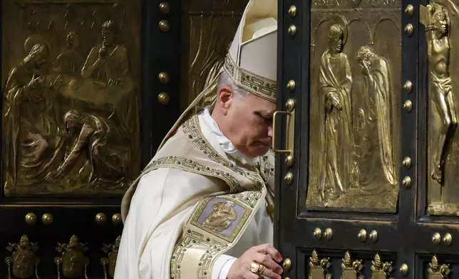 Pope Leo XIV closes St. Peter's Basilica Holy Door to end the 2025 ordinary Jubilee year, at the Vatican, Tuesday, Jan. 6, 2026. (Yara Nardi/Pool photo via AP)