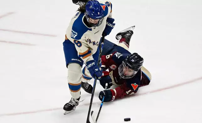 Montreal Victoire's Hayley Scamurra (16) and Vancouver Goldeneyes' Izzy Daniel (8) chase the puck during third-period PWHL hockey game action in Quebec City, Sunday, Jan. 11, 2026. (Jacques Boissinot/The Canadian Press via AP)