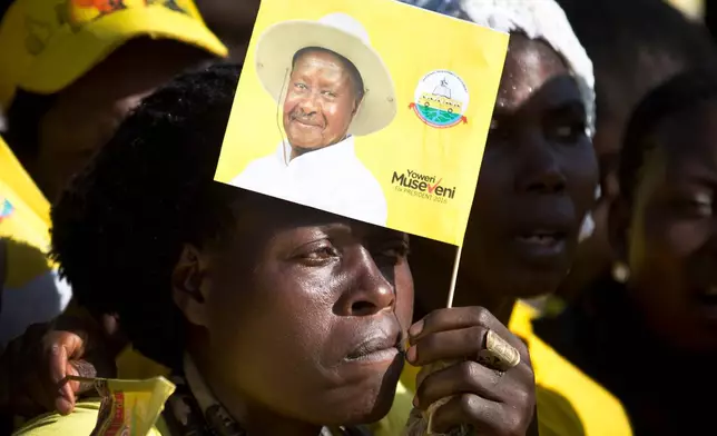 FILE - A supporter holds a flag of Uganda's long-time President Yoweri Museveni at an election rally at Kololo Airstrip in Kampala, Uganda Tuesday, Feb. 16, 2016. (AP Photo/Ben Curtis, File)