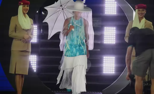 Naomi Osaka of Japan walks onto Rod Laver Arena for her first round match against Antonia Ruzic of Croatia at the Australian Open tennis championship in Melbourne, Australia, Tuesday, Jan. 20, 2026. (AP Photo/Asanka Brendon Ratnayake)