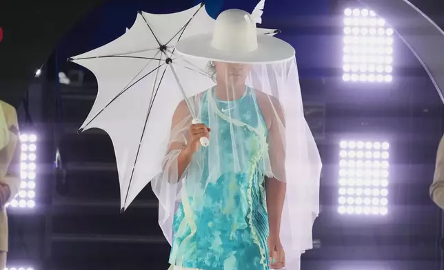 Naomi Osaka of Japan walks onto Rod Laver Arena for her first round match against Antonia Ruzic of Croatia at the Australian Open tennis championship in Melbourne, Australia, Tuesday, Jan. 20, 2026. (AP Photo/Asanka Brendon Ratnayake)