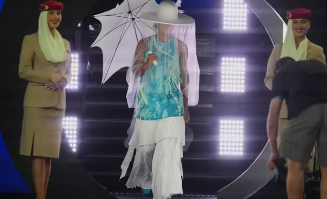 Naomi Osaka of Japan walks onto Rod Laver Arena for her first round match against Antonia Ruzic of Croatia at the Australian Open tennis championship in Melbourne, Australia, Tuesday, Jan. 20, 2026. (AP Photo/Asanka Brendon Ratnayake)