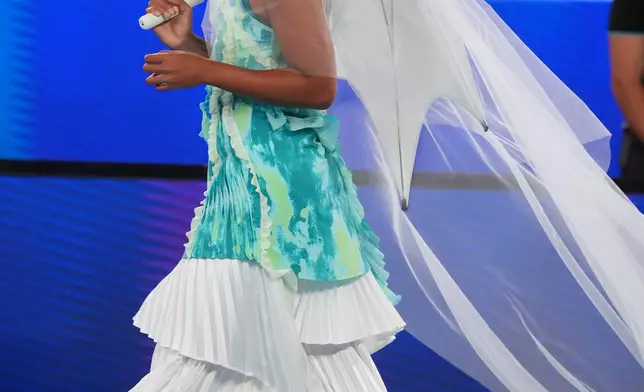 Naomi Osaka of Japan walks onto Rod Laver Arena for her first round match against Antonia Ruzic of Croatia at the Australian Open tennis championship in Melbourne, Australia, Tuesday, Jan. 20, 2026. (AP Photo/Asanka Brendon Ratnayake)