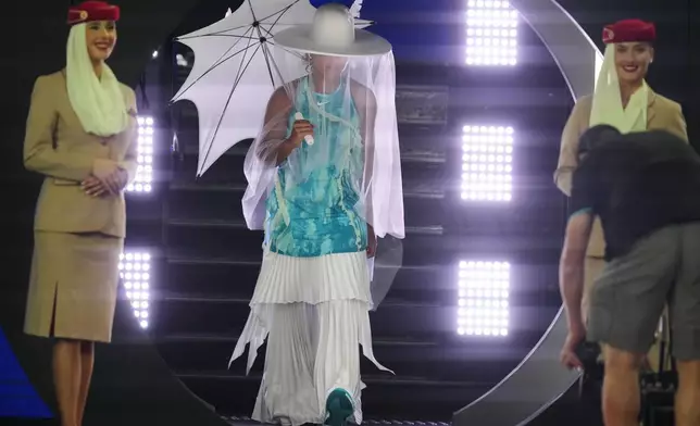 Naomi Osaka of Japan walks onto Rod Laver Arena for her first round match against Antonia Ruzic of Croatia at the Australian Open tennis championship in Melbourne, Australia, Tuesday, Jan. 20, 2026. (AP Photo/Asanka Brendon Ratnayake)