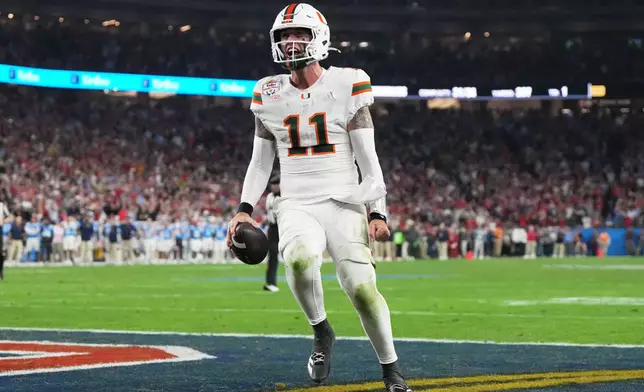 Miami quarterback Carson Beck scores a touchdown during the second half of the Fiesta Bowl NCAA college football playoff semifinal game against Mississippi, Thursday, Jan. 8, 2026, in Glendale, Ariz. (AP Photo/Rick Scuteri)