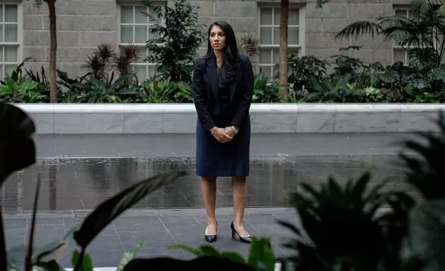 Anam Petit, a former Justice Department employee, poses for a portrait in the Robert and Arlene Kogod Courtyard at the National Portrait Gallery in Washington, Friday, Jan. 9, 2026. (AP Photo/Moriah Ratner)