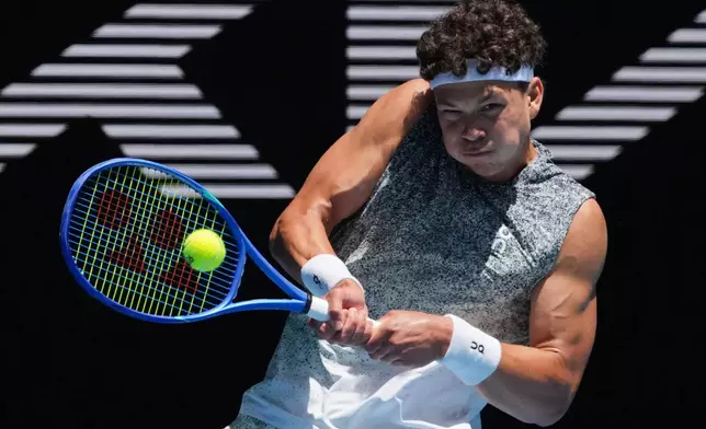 Ben Shelton of the U.S. plays a backhand return to Dane Sweeny of Australia during their second round match at the Australian Open tennis championship in Melbourne, Australia, Thursday, Jan. 22, 2026. (AP Photo/Asanka Brendon Ratnayake)