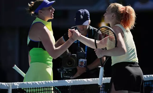 Amanda Anisimova of the U.S. is congratulated by Katerina Siniakova, right, of the Czech Republic following their second round match at the Australian Open tennis championship in Melbourne, Australia, Thursday, Jan. 22, 2026. (AP Photo/Dita Alangkara)