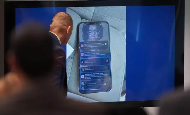 Texas Ranger detective Jason Shea looks at photos of a phone as he gives testimony during a trial for former Uvalde school district police officer Adrian Gonzales at the Nueces County Courthouse in Corpus Christi, Texas, Tuesday, Jan. 6, 2026. (AP Photo/Eric Gay)