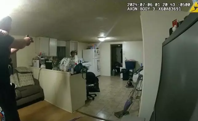 FILE - In this image taken from body camera video released by Illinois State Police on Monday, July 22, 2024, former Sangamon County Sheriff's Deputy Sean Grayson, left, points his gun at Sonya Massey, who called 911 for help, before shooting and killing her inside her home in Springfield, Ill., July 6, 2024. (Illinois State Police via AP, File)