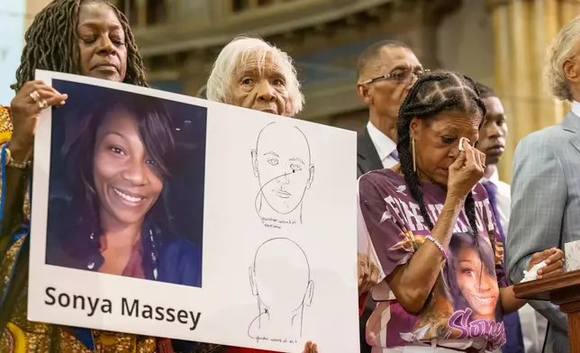 FILE - Donna Massey, center right, wipes tears from her face as she listens to Rev. Al Sharpton, right, speak during a press conference over the shooting death of her daughter, Sonya, who was killed by Illinois sheriff's deputy Sean Grayson, at New Mount Pilgrim Church in Chicago, July 30, 2024. (Tyler Pasciak LaRiviere/Chicago Sun-Times via AP, File)