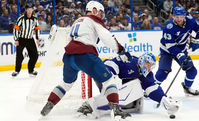 Tampa Bay Lightning goaltender Andrei Vasilevskiy (88) stops a shot by Colorado Avalanche center Brock Nelson (11) during the third period of an NHL hockey game Tuesday, Jan. 6, 2026, in Tampa, Fla. (AP Photo/Chris O'Meara)