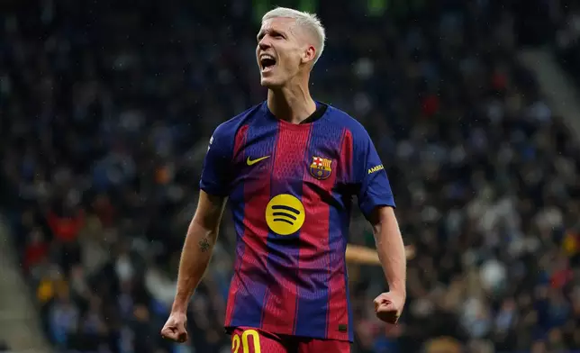 Barcelona's Dani Olmo celebrates scoring his side's opening goal during the Spanish La Liga soccer match between RCD Espanyol and Barcelona in Barcelona, Spain, Saturday, Jan. 3, 2026. (AP Photo/Joan Monfort)
