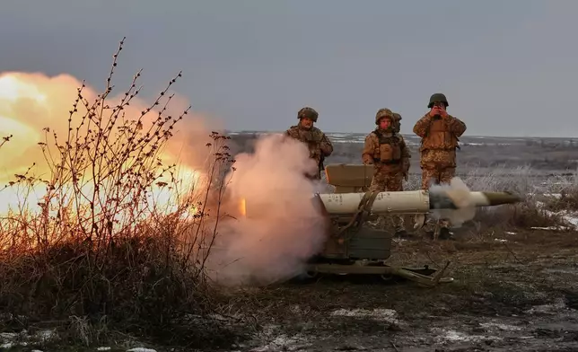 In this photo provided by Ukraine's 65th Mechanized Brigade press service, soldiers fire an anti-tank missile system during a drill close to the frontline on the site of heavy battles with the Russian troops in the Zaporizhzhia region, Ukraine, Sunday, Jan. 4, 2026. (Andriy Andriyenko/Ukraine's 65th Mechanized Brigade via AP)