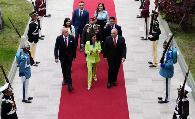 Venezuela's acting President Delcy Rodriguez, center, her brother National Assembly President, Jorge Rodriguez, left, and Interior Minister Diosdado Cabello arrive at the National Assembly in Caracas, Venezuela, Thursday, Jan. 15, 2026. (AP Photo/Ariana Cubillos)
