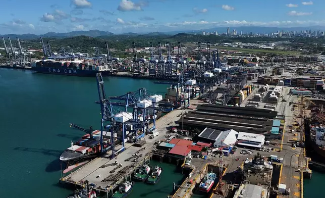 Cranes load a cargo ship at Panama Canal's Port of Balboa, managed by CK Hutchison Holdings, in Panama City, Friday, Jan. 30, 2026. (AP Photo/Matias Delacroix)