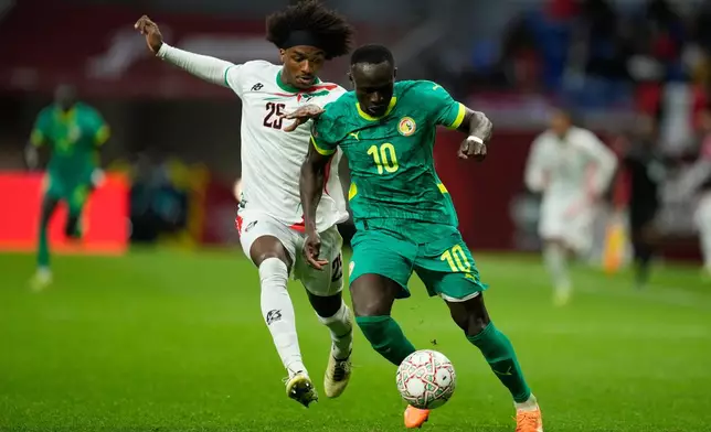 Sudan's Sheddy Ezeldin, left, and Senegal's Sadio Mane fight for the ball during the Africa Cup of Nations best of 16 soccer match between Senegal and Sudan in Tangier, Morocco, Saturday, Jan. 3, 2026. (AP Photo/Mosa'ab Elshamy)