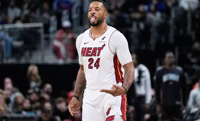 Miami Heat guard Norman Powell celebrates after making a three-point basket during the first half of an NBA basketball game against the Detroit Pistons Thursday, Jan. 1, 2026, in Detroit. (AP Photo/Ryan Sun)