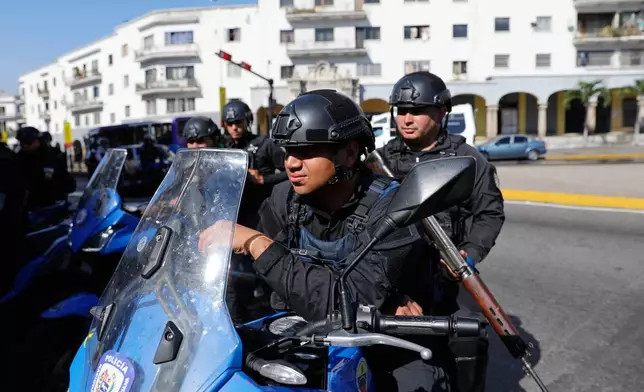 Police patrol in downtown Caracas, Venezuela, Monday, Jan. 5, 2026. (AP Photo/Cristian Hernandez)