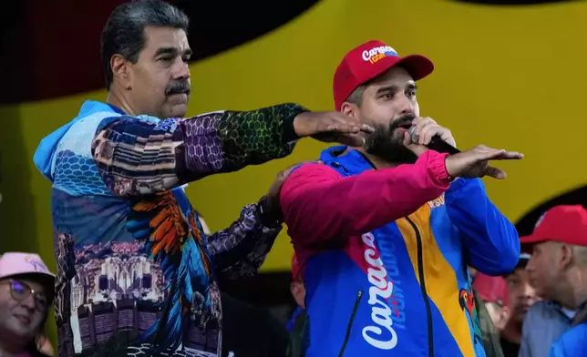 FILE - Venezuelan President Nicolas Maduro, left, and his son Nicolas Maduro Guerra who is running to represent Caracas as a lawmaker for the National Assembly attend a closing campaign rally for the regional election on May 25, in Caracas, Venezuela, May 22, 2025. (AP Photo/Ariana Cubillos, File)