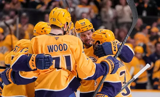 Nashville Predators defenseman Roman Josi (59) celebrates his goal with teammates during the second period of an NHL hockey game against the Edmonton Oilers, Tuesday, Jan. 13, 2026, in Nashville, Tenn. (AP Photo/George Walker IV)