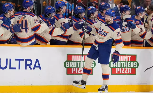 Edmonton Oilers center Leon Draisaitl (29) celebrates his goal with teammates during the second period of an NHL hockey game against the Nashville Predators, Tuesday, Jan. 13, 2026, in Nashville, Tenn. (AP Photo/George Walker IV)