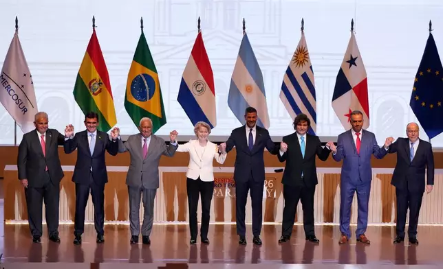 Panama's President Jose Raul Mulino, from left, Bolivian President Rodrigo Paz, European Council President Antonio Costa, European Commission President Ursula von der Leyen, Paraguay's President Santiago Pena, Argentina's President Javier Milei, Uruguay's President Yamandu Orsi and Brazilian Minister of Foreign Affairs Mauro Vieira, pose for a group photo during a meeting to sign a free trade deal between the European Union and Mercosur in Asuncion, Paraguay, Saturday, Jan. 17, 2026. (AP Photo/Jorge Saenz)
