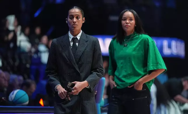 Lunar Owls guard Skylar Diggins, left, and forward Napheesa Collier wear street clothes as they sit out the game with injuries, at the start of their Unrivaled 3-on-3 basketball game against Rose BC, Monday, Jan. 5, 2026, in Medley, Fla. (AP Photo/Rebecca Blackwell)