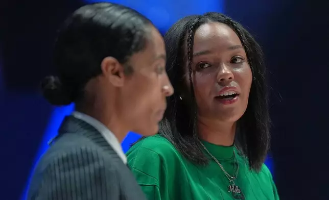 Lunar Owls forward Napheesa Collier, right, talks with guard Skylar Diggins as both sit out with injuries at the start of their Unrivaled 3-on-3 basketball game against Rose BC, Monday, Jan. 5, 2026, in Medley, Fla. (AP Photo/Rebecca Blackwell)