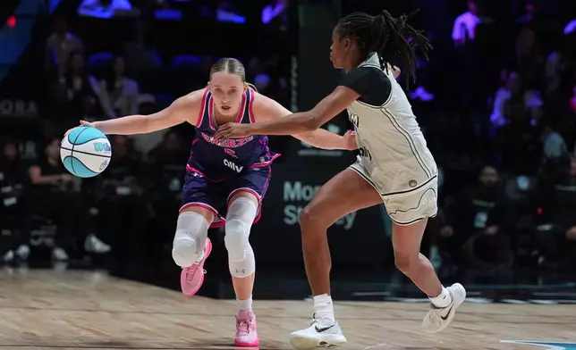 Breeze BC guard Paige Bueckers (5) drives past Phantom BC guard Tiffany Hayes in their Unrivaled 3-on-3 basketball game, Monday, Jan. 5, 2026, in Medley, Fla. (AP Photo/Rebecca Blackwell)