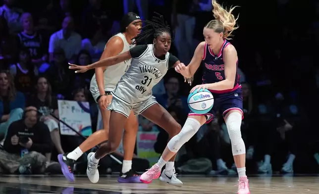 Breeze BC guard Paige Bueckers (5) is defended by Phantom BC guard Tiffany Hayes (31) in their Unrivaled 3-on-3 basketball game, Monday, Jan. 5, 2026, in Medley, Fla. (AP Photo/Rebecca Blackwell)