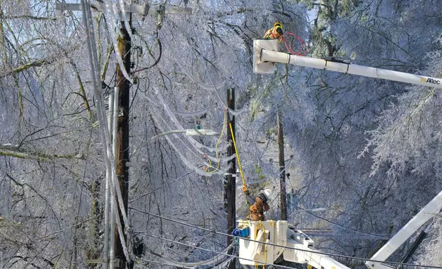 A lineman works to restore power in Oxford, Miss. on Monday, Jan. 26, 2026, following a weekend ice storm. (AP Photo/Bruce Newman)