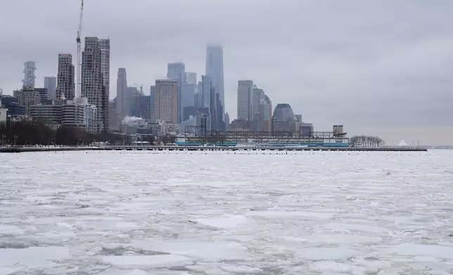 Clouds cover the top of One World Trade, top center, as ice crowds the Hudson River in New York, Monday, Jan. 26, 2026. (AP Photo/Seth Wenig)