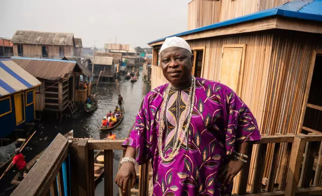 Traditional leader of Makoko, Baale Semede Emmanuel stands outside his home in the coastal community of Makoko, Saturday, Dec. 13, 2025, in Lagos Nigeria. (AP Photo/Grace Ekpu)