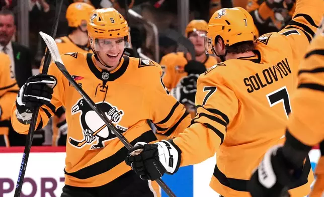 Pittsburgh Penguins defenseman Ryan Shea celebrates his goal with Ilya Solovyov during the second period of an NHL hockey game against the Chicago Blackhawks in Pittsburgh, Thursday, Jan. 29, 2026. (AP Photo/Gene J. Puskar)