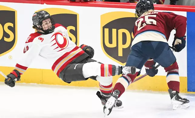 Ottawa Charge's Alexa Vasko (10) is checked by Montreal Victoire's Lina Ljungblom (25) during first period PWHL hockey action in Laval, Que., Tuesday, Jan. 13, 2026. (Graham Hughes/The Canadian Press via AP)