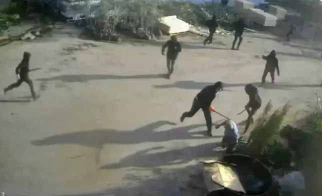 This frame grab from security camera footage filmed Jan. 8, 2026, and obtained by The Associated Press, shows men dressed mostly in black with their faces covered, two of whom are hitting a man on the ground as he tried to flee a nursery in the northern West Bank village of Deir Sharaf. Two people who witnessed the attack and are members of the family that owns the facility said the assailants were Israeli settlers beating 67-year-old Basim Saleh Yassin.(UGC via AP)