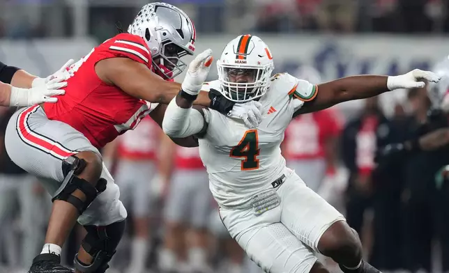 Ohio State offensive lineman Phillip Daniels, left, blocks Miami defensive lineman Rueben Bain Jr. during the first half of the Cotton Bowl College Football Playoff quarterfinal game Wednesday, Dec. 31, 2025, in Arlington, Texas. (AP Photo/Julio Cortez)