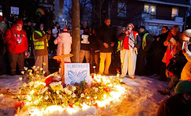 People gather for a vigil after an Immigration and Customs Enforcement officer shot and killed a woman earlier in the day, Wednesday, Jan. 7, 2026, in Minneapolis. (AP Photo/Bruce Kluckhohn)