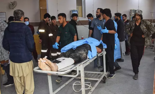 Hospital workers transport a body of a police officer who was killed in a militants attack, at a hospital in Quetta, Pakistan, Saturday, Jan. 31, 2026. (AP Photo/Arshad Butt)