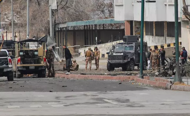 Pakistani army soldiers and other security officials examine a site following militants attack with guns and grenades, in Quetta, Pakistan, Saturday, Jan. 31, 2026. (AP Photo/Arshad Butt)