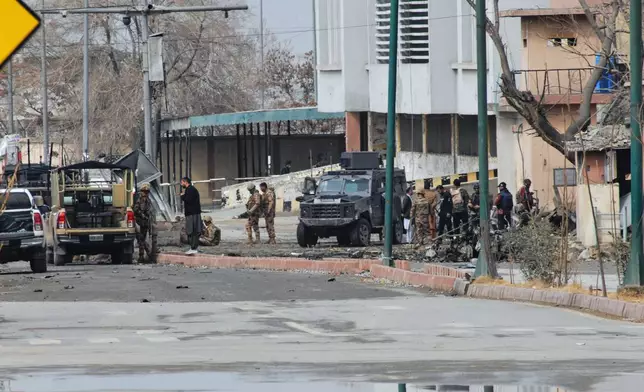 Pakistani army soldiers and other security officials examine a site following militants attack with guns and grenades, in Quetta, Pakistan, Saturday, Jan. 31, 2026. (AP Photo/Arshad Butt)