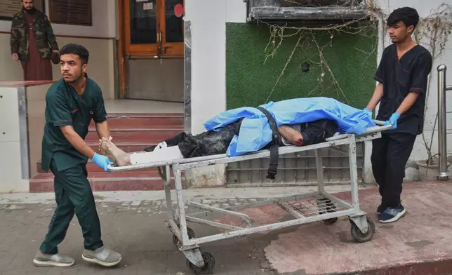 Hospital workers transport a body of a police officer who was killed in a militants attack, outside a hospital in Quetta, Pakistan, Saturday, Jan. 31, 2026. (AP Photo/Arshad Butt)
