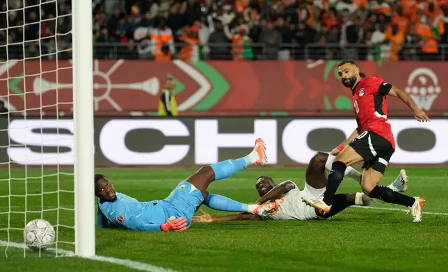 Egypt's Mohamed Salah, right, scores his side's third goal during the Africa Cup of Nations quarterfinal soccer match between Egypt and Ivory Coast, in Agadir, Morocco, Saturday, Jan. 10, 2026. (AP Photo/Mosa'ab Elshamy)