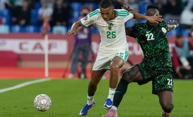 Algeria's Rafik Belghali, left, and Nigeria's Akor Adams challenge for the ball during the Africa Cup of Nations quarterfinal soccer match between Nigeria and Algeria, in Marrakech, Morocco, Saturday, Jan. 10, 2026. (AP Photo/Themba Hadebe)