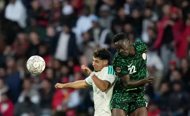 Algeria's Fares Chaibi, left, and Nigeria's Akor Adams challenge for the ball during the Africa Cup of Nations quarterfinal soccer match between Nigeria and Algeria, in Marrakech, Morocco, Saturday, Jan. 10, 2026. (AP Photo/Themba Hadebe)