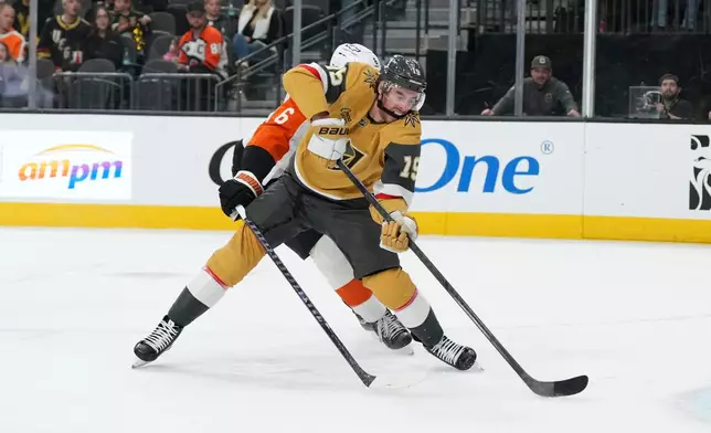 Vegas Golden Knights right wing Reilly Smith (19) shoots against Philadelphia Flyers defenseman Travis Sanheim (6) during the second period of an NHL hockey game Monday, Jan. 19, 2026, in Las Vegas. (AP Photo/Candice Ward)