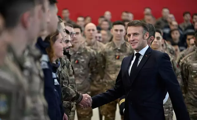 French President Emmanuel Macron shakes with soldiers as he visits the Istres military air force base, southern France, Thursday, Jan. 15, 2026. (AP Photo/Philippe Magoni, Pool)