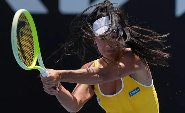 Priscilla Hon of Australia plays a backhand return to Marina Stakusic of Canada during their first round match at the Australian Open tennis championship in Melbourne, Australia, Monday, Jan. 19, 2026. (AP Photo/Dar Yasin)