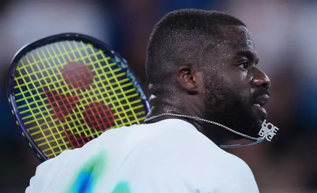 Frances Tiafoe of the U.S. plays a forehand return to Francisco Comesana of Argentina during their second round match at the Australian Open tennis championship in Melbourne, Australia, Wednesday, Jan. 21, 2026. (AP Photo/Asanka Brendon Ratnayake)